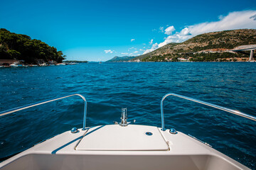 side front of a motor yacht going to the sea towards the mountains. Luxurious travel life....