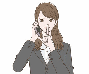 スマートフォンを持ち、人差し指を口にあてるスーツの女性