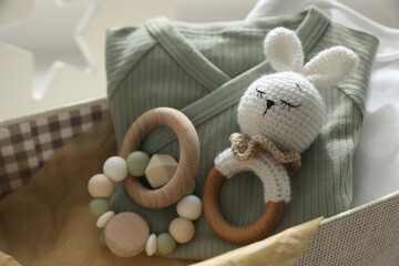 Box with baby clothes and toys, closeup