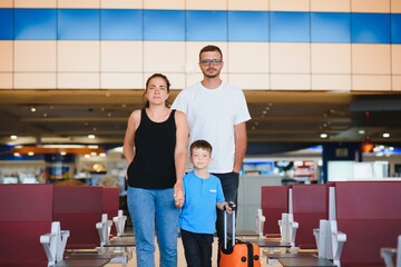 Fototapeta na wymiar Portrait of traveling family with suitcases in airport