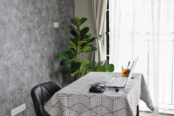 A home office desk that is nicely decorated and comfortable.