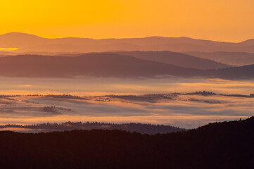 Morning mists illuminated by the rays of the rising sun seen from the summit of Połonina Wetlińska, the Bieszczady Mountains, the Carpathians