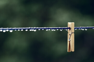 Clothes pin on laundry line during a wet day.