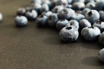 Blueberries ripe and tasty on a black background. Berries close up, Texture blueberry.