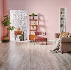 Pink and white brick wall background bookshelf wooden cabinet and green plant, interior style.