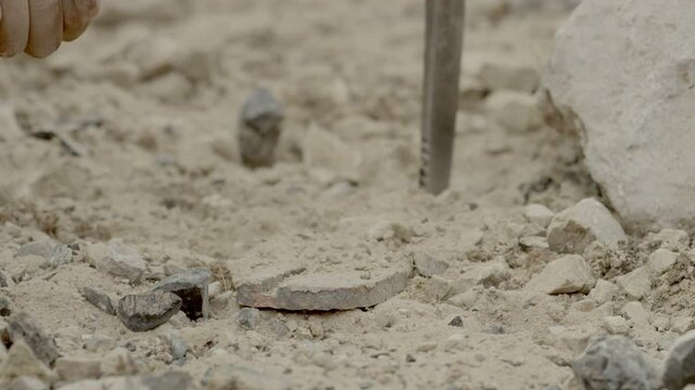 Miner breaking rock by digging axe and after find something like metal . Close up of pick axe hitting rocks .  Shot on RED EPIC DRAGON Cinema Camera in slow motion.