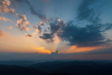 Morning clouds illuminated by the rays of the rising sun seen from the summit of Połonina Wetlińska, the Bieszczady Mountains, the Carpathians