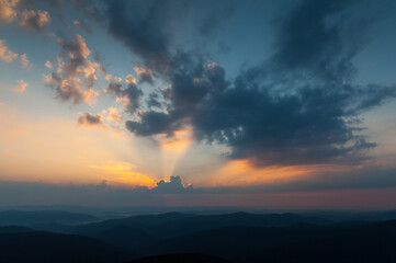 Morning clouds illuminated by the rays of the rising sun seen from the summit of Połonina Wetlińska, the Bieszczady Mountains, the Carpathians