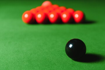 snooker balls on green surface, shallow depth of field