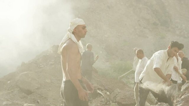 A group of miners or gold diggers are working . Many workers are mining with pickaxe in a quarry . Scenic shot in vintage style with artists . Shot on RED EPIC Cinema Camera in slow motion.