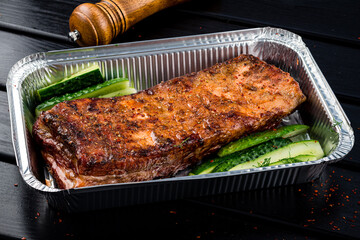 BBQ grilled ribs in a metal tray for delivery. Take out concept, eating at home
