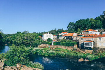 Fototapeta na wymiar Small middle age village. view from the stone bridge.