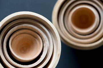 retro blank unpainted wooden nesting dolls or egg objects photographed from above with ambient...