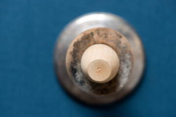 isolated wooden object in a candle stick holder on a dark blue background