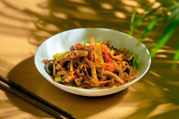 Sweet and sour pork with wok vegetables in a white bowl. Chinese cuisine.