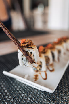 Delicious sushi rolls on plate in restaurant
