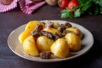 From traditional delicious Turkish food; potato and meat dish in casserole (Turkish name; Guvec tas kebabi, tandir)