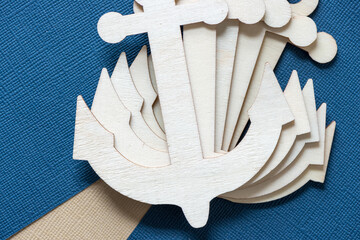 multiple laser-cut plywood anchor shapes on a paper background
