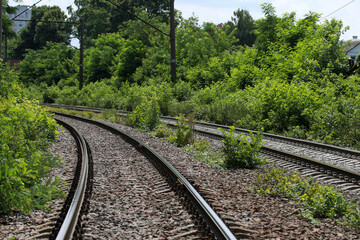 Fototapeta na wymiar The railway, bushes and building