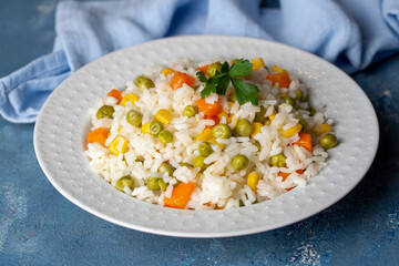 Delicious vegetable rice pilaf with green peas, carrots and sweet corn