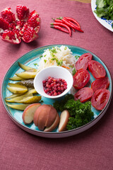 Different pickled vegetables sliced for snack on a plate