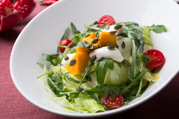 Fresh green vegetarian salad with pumpkin and seeds