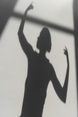 Fototapeta premium Shadow of elegant ballerina on grey background