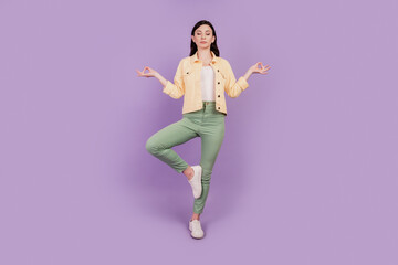 Portrait of calm peaceful girl meditate close eyes harmony concept on purple background