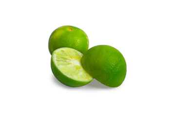 One fresh green full and halved lemon on a white background.