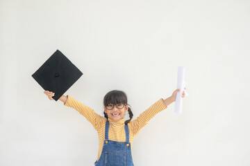 children girl wearing a graduate cap over white background very happy and excited doing winner gesture with arms raised, smiling and screaming for success. Celebration concept.