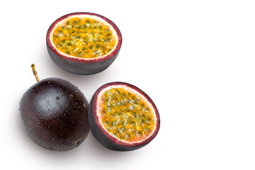 Passion fruit with cut in half sliced isolated on white background. Top view. Flat lay.
