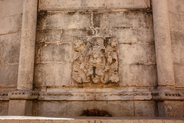 Detail of some stone carved lion heads on a fountain in Dubrovnik, Croatia