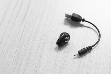bluetooth headphones on wooden background