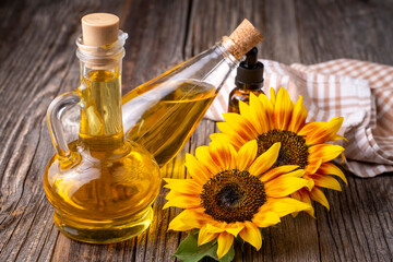 Sunflower and sunflower oil on the wooden background