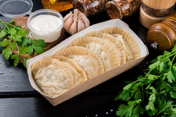 Ukrainian food. Dumplings, Vareniki in paper plate for delivery. Street food concept.