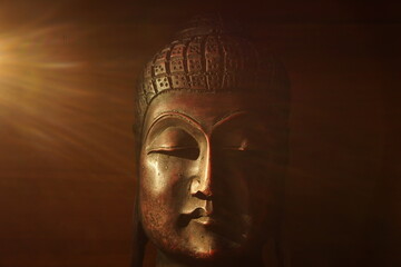Statue of Buddha web banner concept with copy space with a light rays and plain background