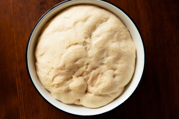 Process of raising the dough in a special basket. Dough made from natural sourdough. Wheat dough. Fermentation. Top view.	