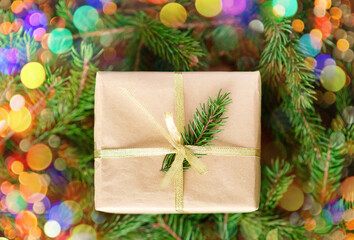 Christmas background, green pine branches festive background. Creative composition with border and copy space. New year decoration with bokeh lights from light bulbs