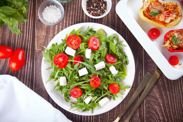 Fresh spring salad with arugula, feta cheese and tomatoes