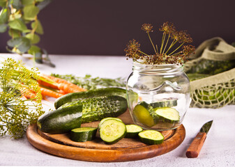 Pickled marinated cucumbers in a kitchen table with dill, spices and garlic
