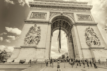 Fototapeta na wymiar PARIS, FRANCE - JUNE 20, 2014: Tourists enjoy Triumph Arc view on a sunny day. More than 30 million people visit Paris every year