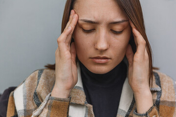 Close-up portrait of woman with headache