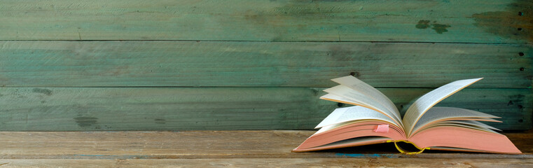 open vintage book on grungy background. Reading,literature,education,library,home office, back to school concept,panoramic, copy space