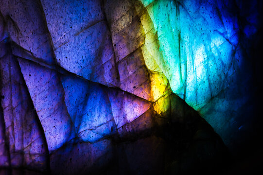 Detail of colorful multicolored (blue, yellow, purple, cyan) labradorite gemstone. Close-up of the texture