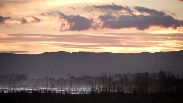Dark clouds at sunset over sea beach. Nature, coastal landscape. Capi Corb, Mediterranean coast of Spain.