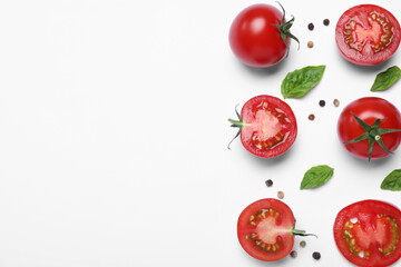 Fototapeta premium Fresh basil leaves and tomatoes on white background, flat lay. Space for text