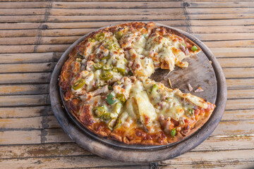 Pizza on wooden tray.