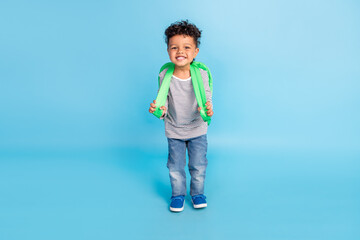 Full length body size view of handsome cheerful boy going to primary academic school isolated over bright blue color background