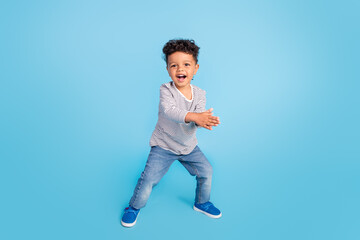 Full length body size view of attractive cheerful boy dancing clapping palms isolated over bright blue color background