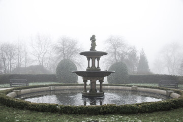 English park in the fog and mist, gloomy and broody mood, contemplate and melancholy, goth feel.